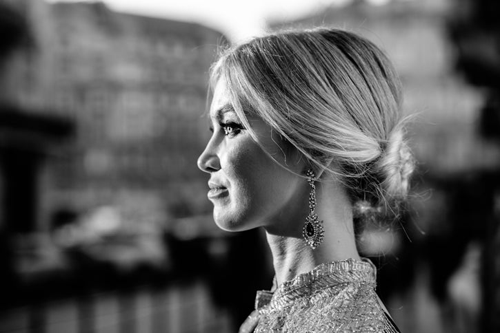 Young white european woman in a city street wearing luxury jewelry 