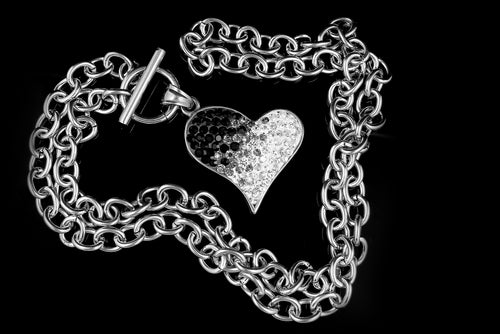 Heart sterling silver necklace for women on a black background 